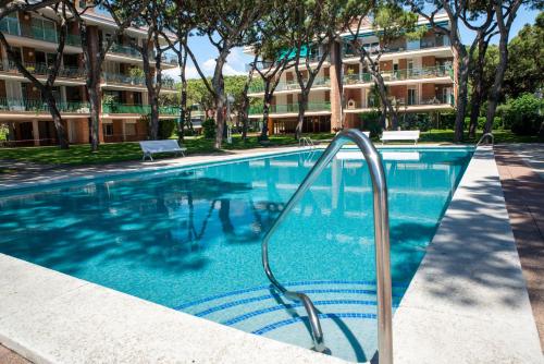 a swimming pool with a slide in front of a building at Wonderful apartment in Gavà. Barcelona in Gavà