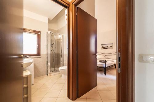 a bathroom with a toilet and a sink at Villa Cala Sinzias in Castiadas