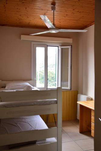 a bedroom with two bunk beds and a window at Les Oliviers Villa with Sea view on Petani Beach in Vovikes