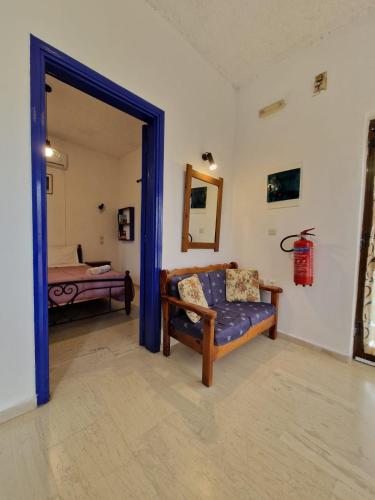 a living room with a couch and a bed at Stefanos Garden in Arménoi