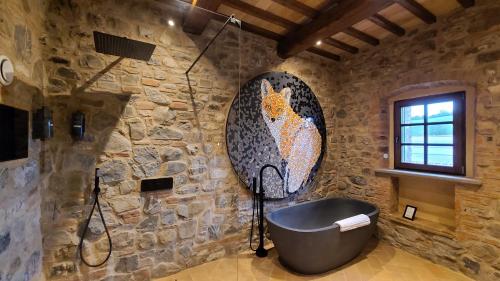 a bathroom with a bath tub in a stone wall at La Torre sulla via Francigena in Gambassi Terme