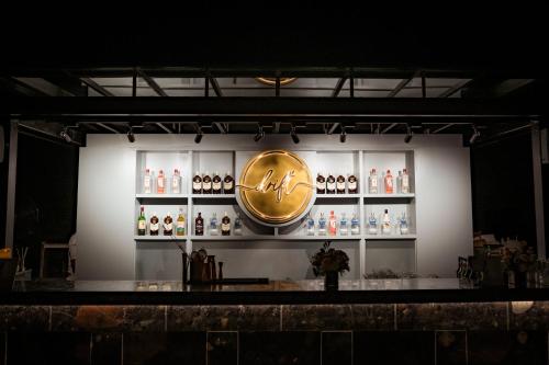 a bar with a large gold clock on a wall at The Westin Goa in Vagator
