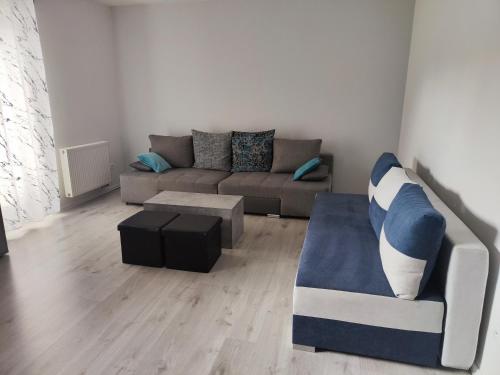 a living room with a couch and a coffee table at Apartman Kuzmanyho Žilina centrum in Žilina
