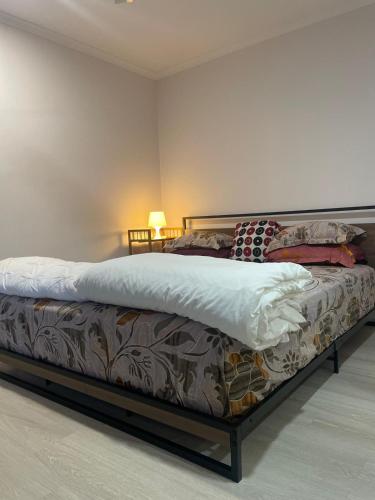 a large bed in a room with a bed frame at 76 Companion Crescent in Higgins
