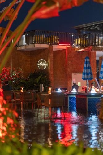 a restaurant with a swimming pool at night at The Westin Goa in Vagator