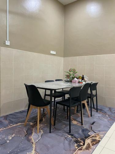 a dining room with a table and four chairs at Laman Bangau Temerloh in Temerloh