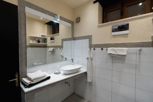 a bathroom with a sink and a mirror at Traditional Stone House - Where Tradition Meets Comfort in Mesa Chorio