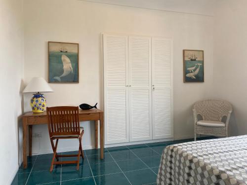 a bedroom with a desk and a chair and a bed at Villa Claudia in Anacapri