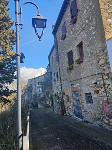 a street light next to an old stone building at La dolce vita Giove apartment in Giove