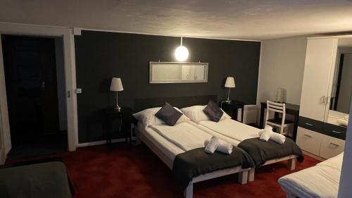 a bedroom with a large bed with two pillows at B&B Osteria Morganti in Someo