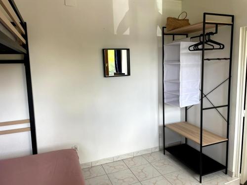 a room with a black book shelf next to a wall at La Capiniella in La Chapelle-Moulière