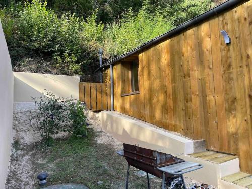a wooden building with a staircase and a fence at La Capiniella in La Chapelle-Moulière