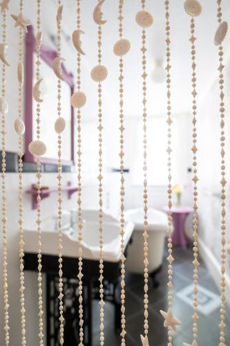 a string of pearl beads hanging from a wall at Enchanted Manor in Niton