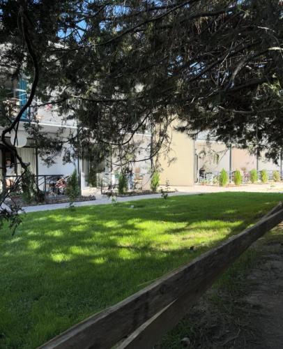 a green lawn with a building in the background at Квартиры под соснами in Cholpon-Ata