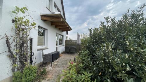 a house with a pathway leading to the front door at Ferienhaus An der Weinrebe in Bad Hersfeld mit Garten, 2 Bäder, 2 Schlafzimmer & Küche - gratis Parkplätze in Bad Hersfeld