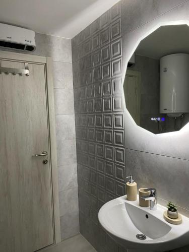 a bathroom with a sink and a mirror at Astera 4 in Vrnjci