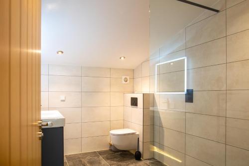 a bathroom with a toilet and a shower at Beautiful Barn Conversion - Orchard Escape for 12! in Cropthorne