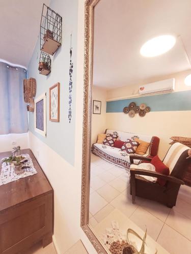 a mirror in a living room with a couch at תכלת המדבר in Mitzpe Ramon