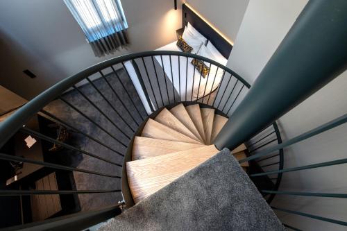 a spiral staircase in a house at Best Western Premier Le Chapitre Hotel and Spa in Remiremont