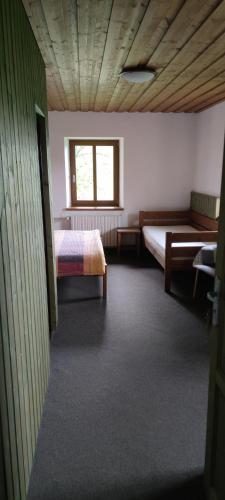 a room with two beds and a window at Hájenka Nebe-apartmán NEBE in Kašperské Hory