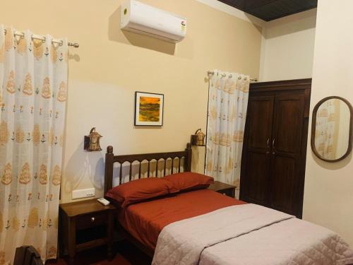a bedroom with two beds and a mirror at Eden Casa in Mararikulam