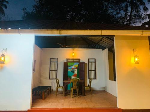 a patio with a table and chairs under a roof at Eden Casa in Mararikulam