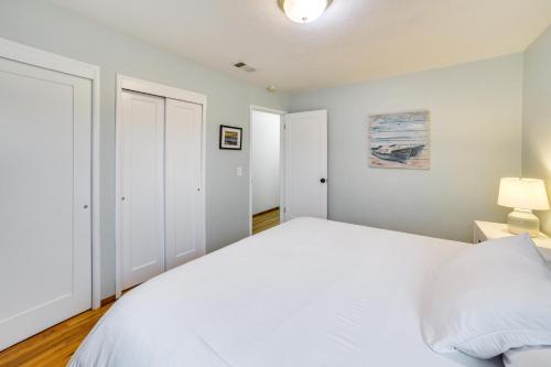 a bedroom with a large white bed and two closets at Seaside Vacation Rental with Patio Near Monterey Bay in Seaside
