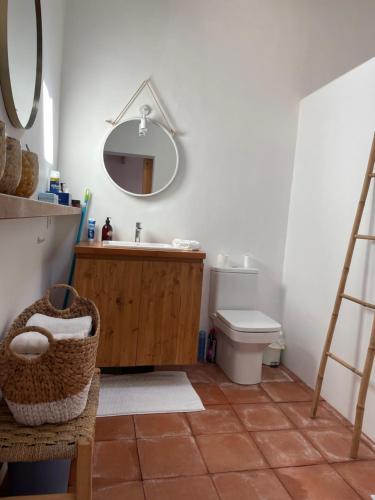 a bathroom with a sink and a toilet and a mirror at Maison de village avec piscine à 10 min de la plage Costa Brava in Sant Feliu de Guixols
