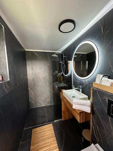 a bathroom with a sink and a mirror at Villa Selya - Private Pool & Mountain View in Selyanin