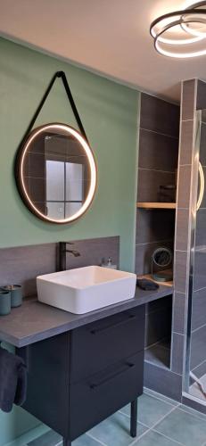 a bathroom with a sink and a mirror at La Maison des Poulains in Sauzon