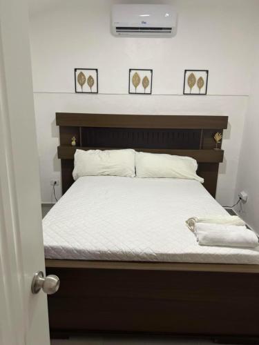 a bedroom with a bed with a wooden headboard at HUMMINGBIRD CABARETE in Cabarete