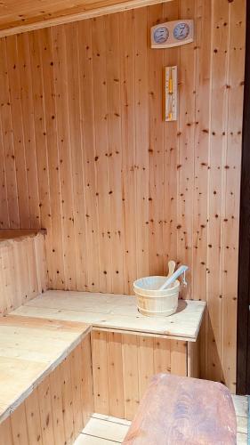 a wooden sauna with a basket on a table at Akhalsheni House in Batumi
