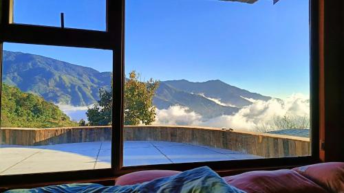 a room with a window with a view of mountains at Cloud Garden in Bắc Yên
