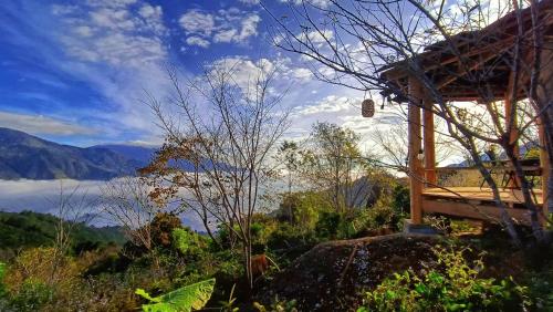 a house on a hill with a view of a valley at Cloud Garden in Bắc Yên