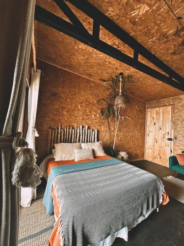 a bedroom with a bed in a brick wall at Alojamiento Concepción, Tomé, Cocholgüe in Concepción