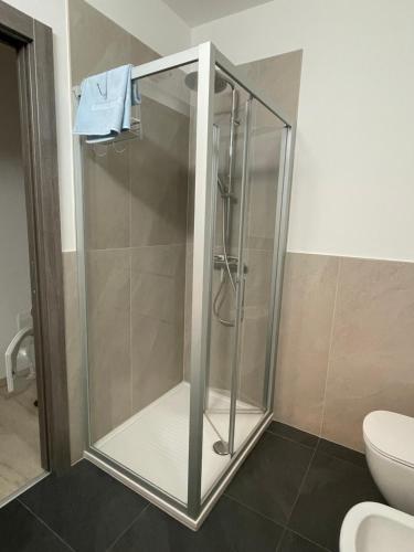 a glass shower in a bathroom with a toilet at Casa Silvia in Morbegno