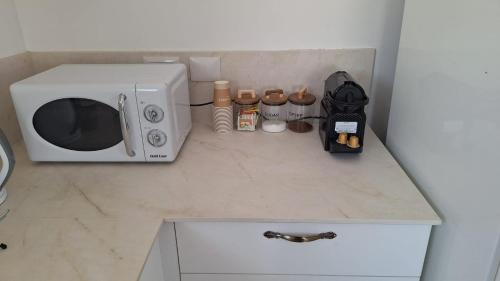 a microwave sitting on top of a kitchen counter at רגעים בגולן in Keshet