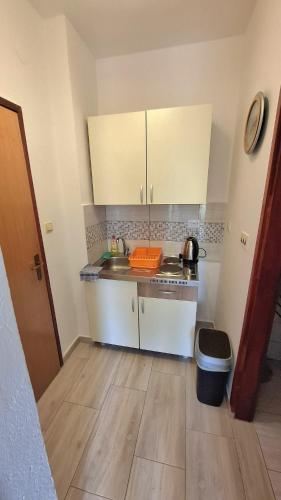 a small kitchen with a sink and a counter at Guesthouse Martina in Senj