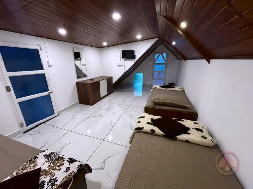 a room with two beds and a tv in it at Minnaminni Estates in Munnar