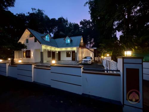 a house with lights on it at night at Minnaminni Estates in Munnar