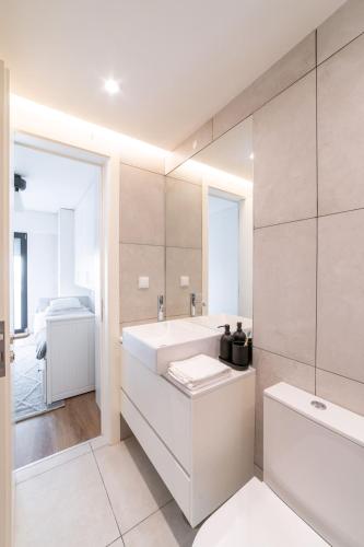 a bathroom with a sink and a toilet and a tub at Lusíadas 53 1ºE in Lisbon