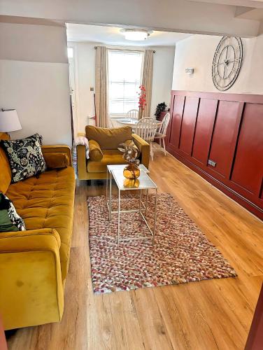 a living room with a couch and a table at Stylish Uphill Townhouse in Lincoln