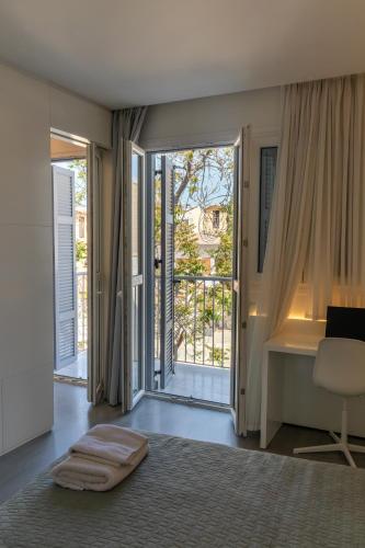 a bedroom with a bed and a desk and a window at City Centre Studio Apartments Nicosia in Nicosia