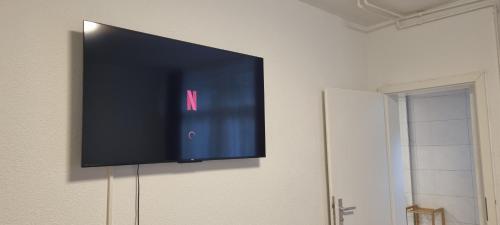 a flat screen tv hanging on a wall at City Apartment 2 Triberg in Triberg