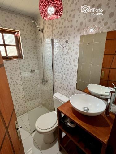 a bathroom with a toilet and a sink and a shower at Chimuelo, es necesario hacer sena para reservar in Punta Del Diablo