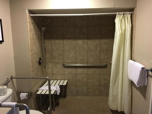 a bathroom with a shower with a shower curtain at Super 8 by Wyndham Salinas in Salinas
