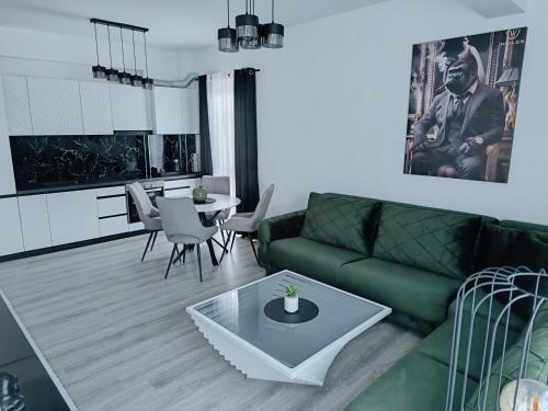 a living room with a green couch and a table at Cozy Home in Ulcinj
