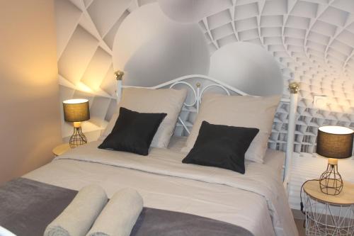 - une chambre avec un lit blanc et 2 lampes dans l'établissement Domaine Le Vernet, à Dore-lʼÉglise