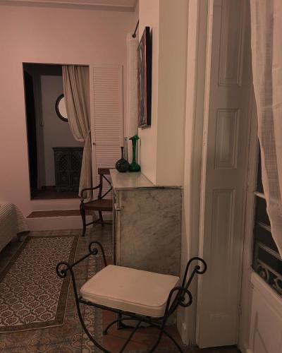 a room with a chair and a table and a window at L Oranger in Rivesaltes
