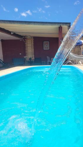 a pool of water spraying into the air at Pousada das Artes 2 in Mongaguá